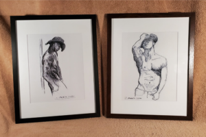 Original art of shirtless gay cowboys framed in black.