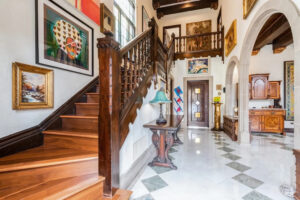 Entrance hall. Mansion in the Jackson Park Highlands, Chicago. Photograph. Facial face, gay male pen & ink figure drawing. 